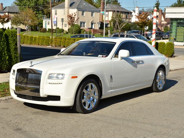 White Rolls Royce Phantom parked on a suburban road